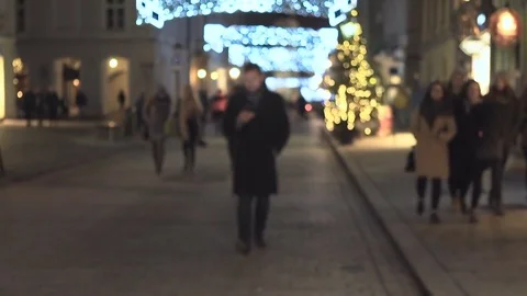 Man sms typing by smartphone app, walks up and goes, night, christmas, steadycam 库存影片 72782014