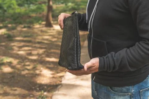 Man with snakeskin python handbag on nature background. 写真素材