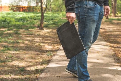 Man with snakeskin python handbag on nature background. 스톡 사진
