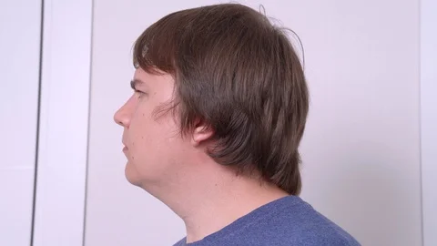 Man sniffs around finds something unpleasant smelling, plugs nose with disgust Stock Footage 129506273