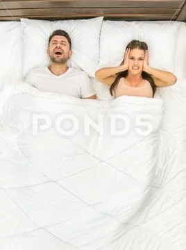 The man snore on the bed. View from above Stock Photos