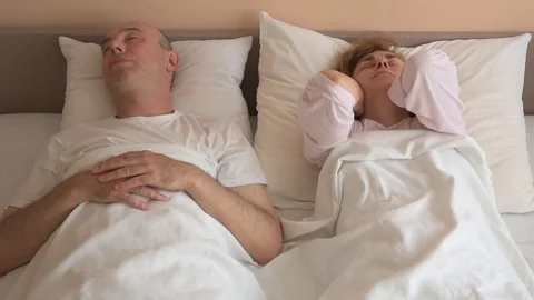 Man snoring while woman cannot sleep Stock Footage 112976231