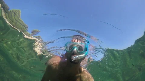 Man snorkeling in Alghero turquoise water Stock Footage