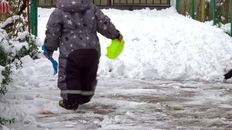 Man with snow shovel cleans sidewalks in winter Stock Footage 101074485