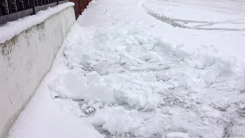 Man with snow shovel cleans sidewalks in winter Stock Footage 101074775
