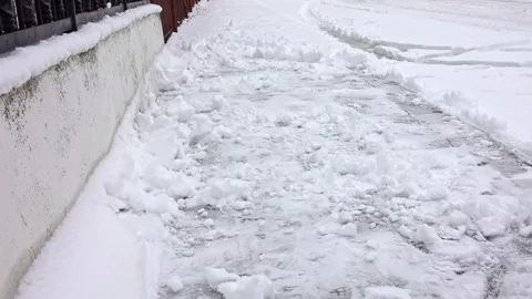 Man with snow shovel cleans sidewalks in winter 스톡 동영상 101074959