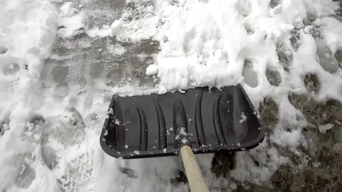 Man with snow shovel cleans sidewalks in winter Video stock 104082222
