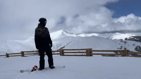 Man on snowboard overlooking Copper mountain Video stock 276384603