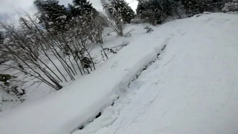 Man snowboarder taking selfie while sliding down by slope Stock Footage 150045042