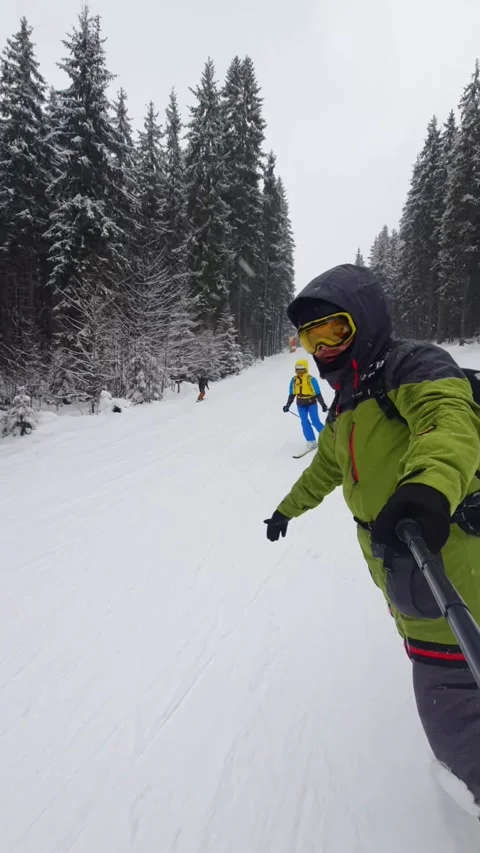 Man snowboarder taking selfie while going down by slope Stock Footage 219307450