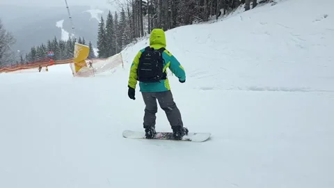 Man snowboarding down by slope Stock Footage 147675748