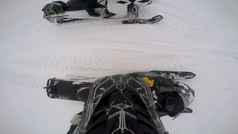 Man on a snowmobile explains something to another man Video stock 102208365