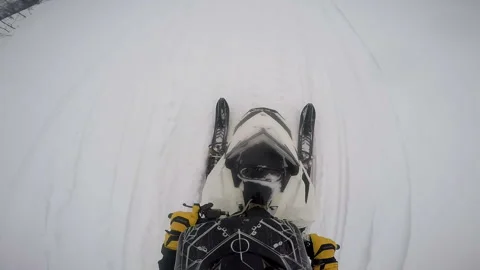 Man on a snowmobile rides forward and looks around Video stock 102207678