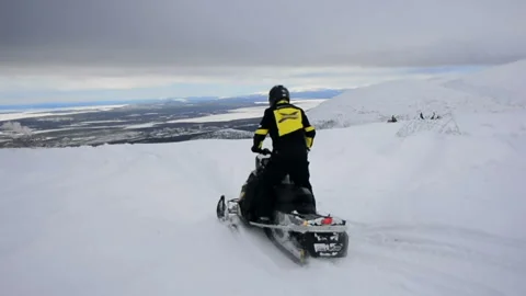 Man on a snowmobile rides on irregularities Video stock 102206117