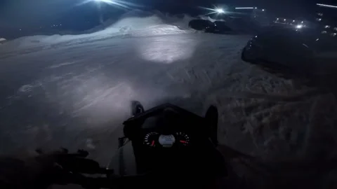 Man on a snowmobile rides on parking Video stock 102163752