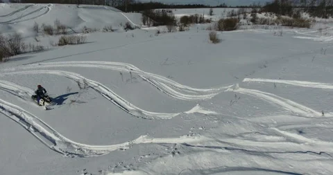 Man on snowmobile in winter mountain Stock Footage 87937757