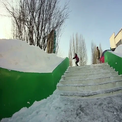 Man on snowskate slides on the ledge Stock Footage 69701645