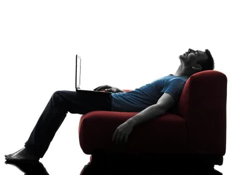 Man sofa couch computer computing laptop Stock Photos