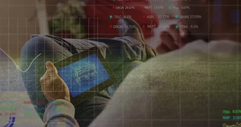 Man on sofa exploring 3D blueprint for analysis, stock tickers scrolling and AR Stock-Footage 310972247