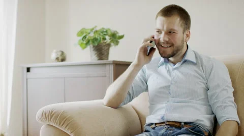 Man on sofa with mobile phone Stock Footage 66049437