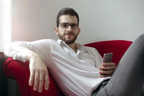 Man on sofa Stock Photos