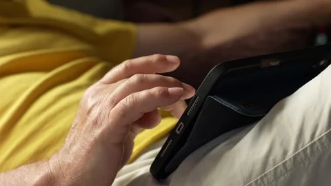 Man on the sofa scrolls the news feed Stock Footage 276282143