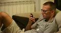 A man on sofa with smartphone HD Footage