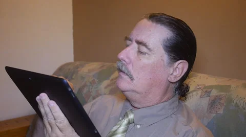 Man on sofa with tablet-Ipad Stock Footage 54659039