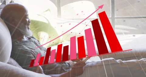 Man on sofa tapping tablet screen plotting animated red pink bar chart for Stock Footage 313703506