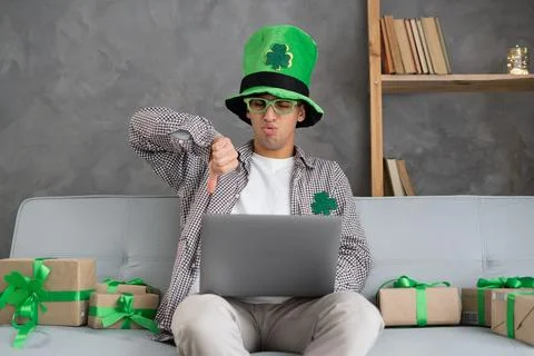 Man on sofa using laptop doing online shopping showing thumbs down bad onli.. Stock Photos