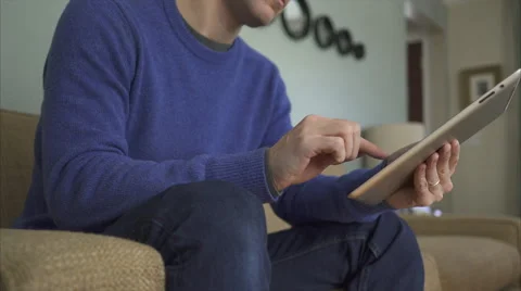 A Man on a Sofa Using The Latest Technology in 4K (1 of 9) Stock Footage 47311740