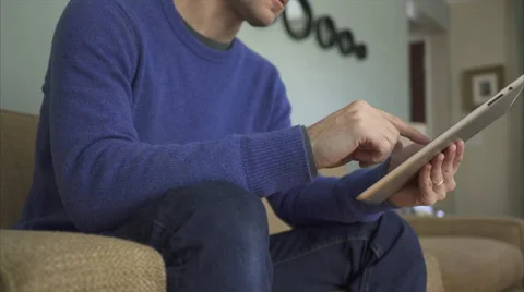 A Man on a Sofa Using The Latest Technology in 4K (2 of 9) Stock Footage 47312993
