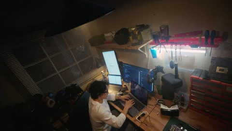 Man Software Developer Coding on Laptop with Multiple Screens Stock Footage 338424398
