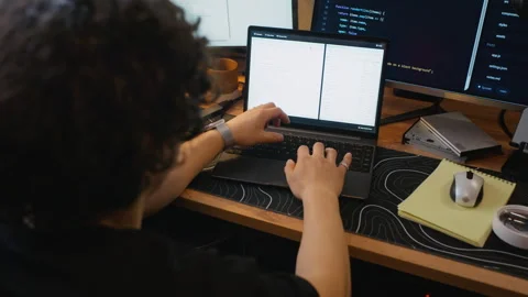 Man Software Developer Typing Code on Laptop at Workstation Stock Footage 338423385