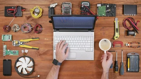 Man software engineer working at a desk with a laptop and a cup of coffee Stock Footage 72414440
