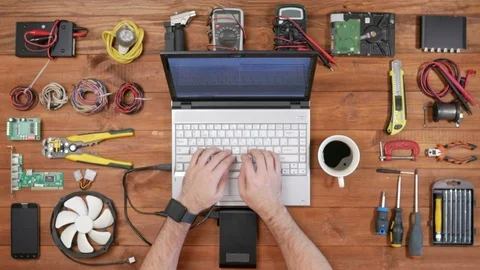 Man software engineer working with a laptop and an external hard drive. Wooden Video stock 72415281