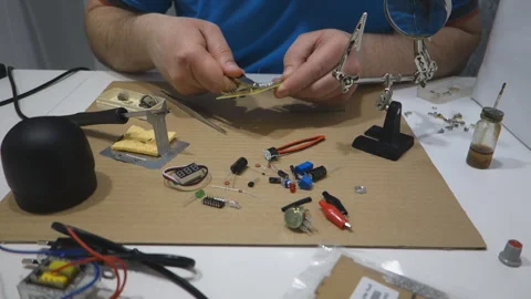 Man solder repairs electronics Stock Footage 327588704