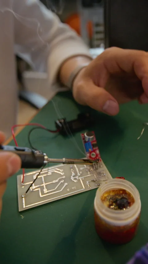 Man Soldering Components on Printed Circuit Board with Smoke Stock Footage 338421951