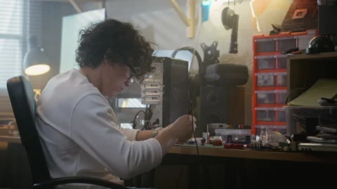 Man Soldering Computer Motherboard in Electronics Workshop Stock Footage 338422857