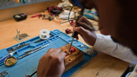 Man Soldering Electronic Component for Robot Assembly Stock Footage 343507209