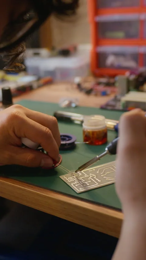 Man Soldering Electronic Components on Circuit Board in Workshop Stock Footage 338421857