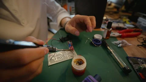 Man Soldering Electronic Components on Circuit Board in Workshop Stock Footage 338421931