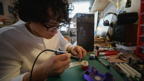 Man Soldering Electronic Components on Circuit Board Stock Footage 338422779