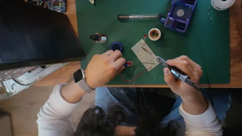 Man Soldering Electronic Components on Circuit Board Overhead Stock Footage 338422935