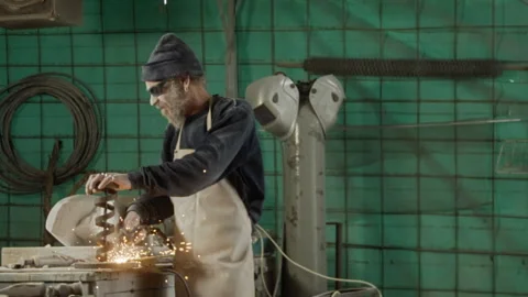Man soldering metal in a workshop Stock Footage 274948572
