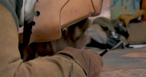 Man soldering two pieces of copper together wearing protective gear Stock Footage 102723022