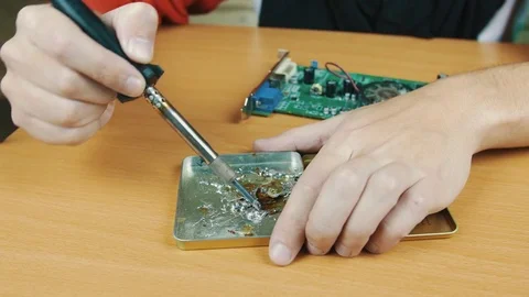 The man solders a chip Stock Footage 70598105