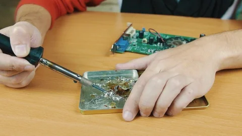The man solders a chip Stock Footage 70598447