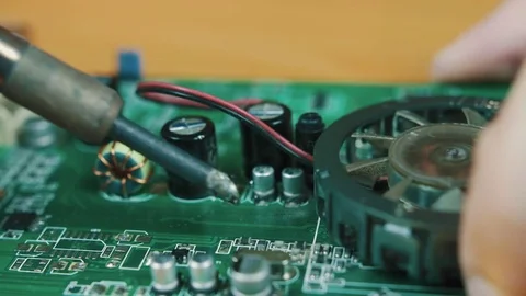 The man solders a chip Stock Footage 70600814