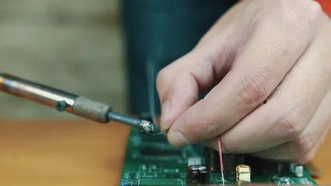 The man solders a chip Stock Footage 70602682